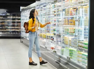 femme devant une vitrine qui compare deux produits